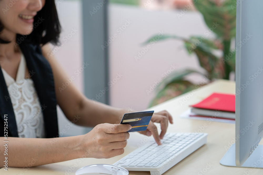 Asian beauty woman shopping online by hand hold credit card and input number with keyboard computer laptop Asian beauty woman shopping online by hand hold credit card and input number with keyboard computer laptop