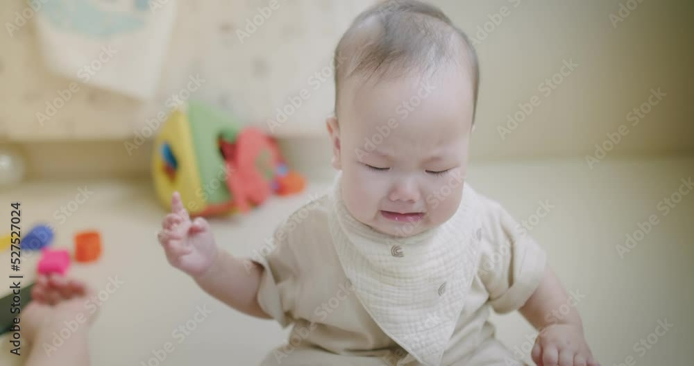 portrait innocence unhappy little asian baby infant toddler kid child are crying sad scream pain and angry emotion expression upset face while sitting alone in living room at home portrait innocence unhappy little asian baby infant toddler kid child are crying sad scream pain and angry emotion expression upset face while sitting alone in living room at home