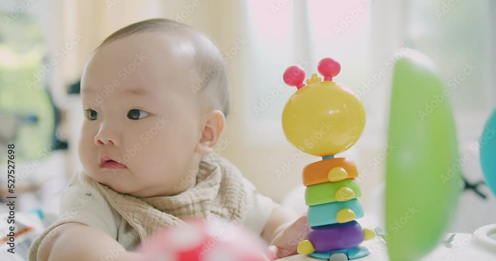 Portrait adorable little cute Asian baby infant child toddler sitting and playing colorful toys with fun in living room at home, lifestyle learning creative development education childhood concept Portrait adorable little cute Asian baby infant child toddler sitting and playing colorful toys with fun in living room at home, lifestyle learning creative development education childhood concept