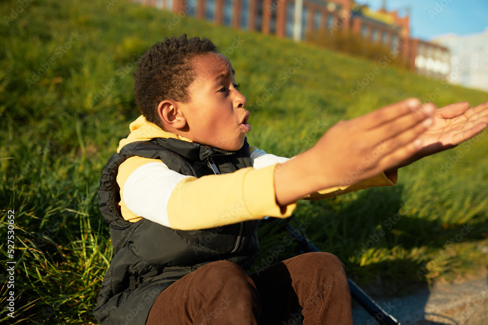 Indignant scared anxious african american child reaching hands asking