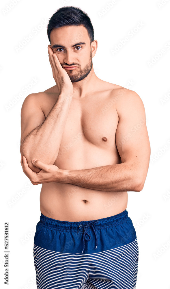 Fototapeta premium Young handsome man wearing swimwear thinking looking tired and bored with depression problems with crossed arms.