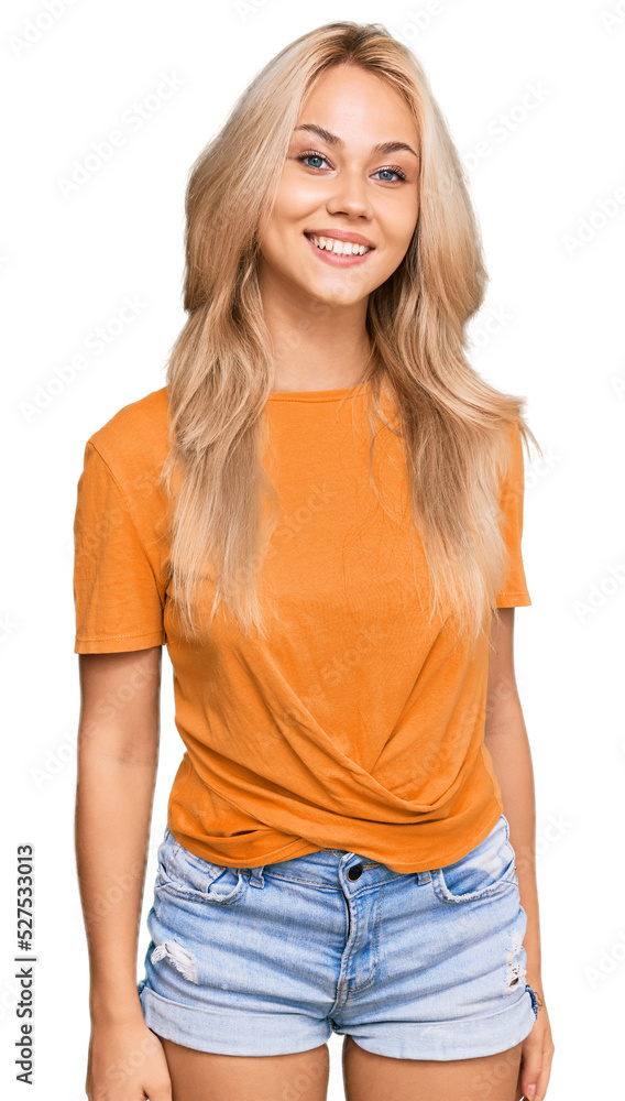 Young blonde girl wearing casual clothes looking positive and happy standing and smiling with a confident smile showing teeth Young blonde girl wearing casual clothes looking positive and happy standing and smiling with a confident smile showing teeth