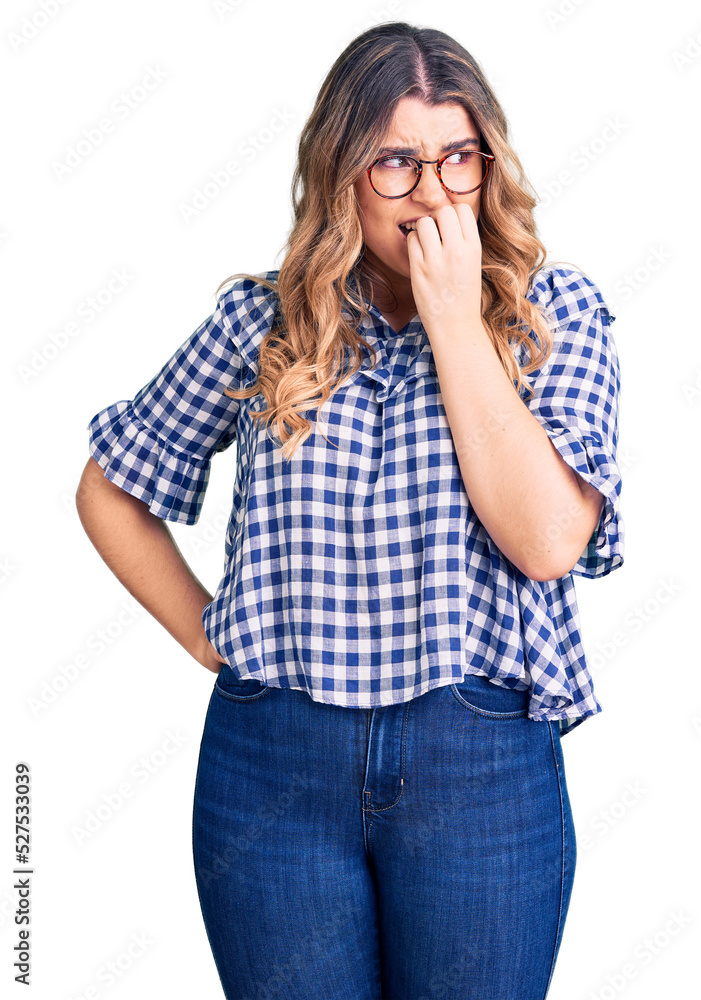 Young caucasian woman wearing casual clothes looking stressed and nervous with hands on mouth biting nails. anxiety problem. Young caucasian woman wearing casual clothes looking stressed and nervous with hands on mouth biting nails. anxiety problem.