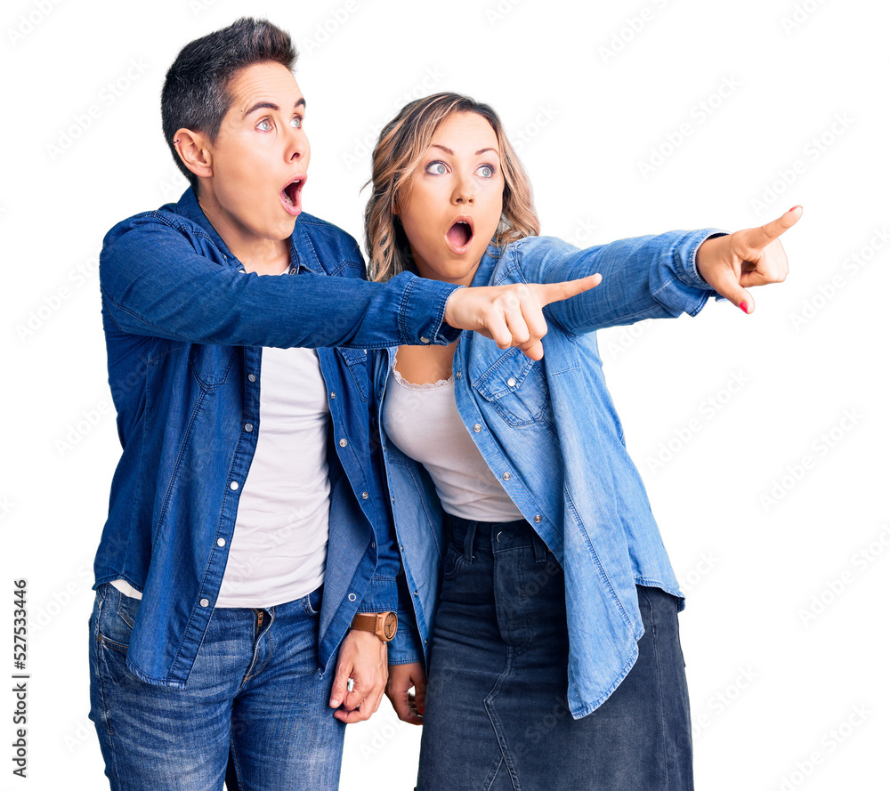 Obraz premium Couple of women wearing casual clothes pointing with finger surprised ahead, open mouth amazed expression, something on the front