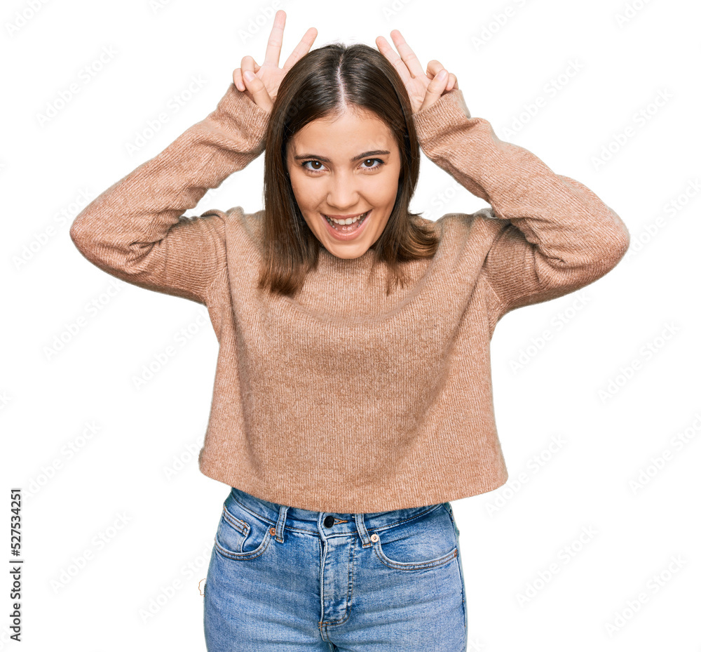 Young beautiful woman wearing casual clothes posing funny and crazy with fingers on head as bunny ears, smiling cheerful Young beautiful woman wearing casual clothes posing funny and crazy with fingers on head as bunny ears, smiling cheerful