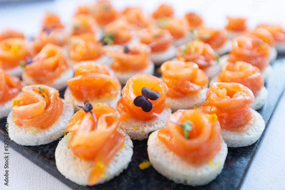 Salmon roll served at a wedding buffet. Gourmet aperitif at a party consisting of finger food. Salmon roll served at a wedding buffet. Gourmet aperitif at a party consisting of finger food.