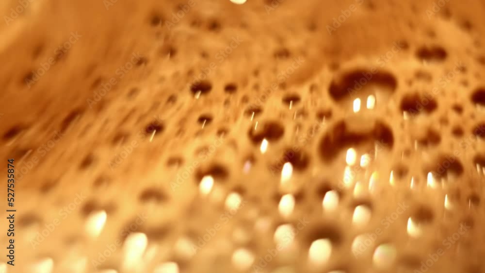 Bubbles with froth on surface of hot cocoa being stirred close-up high angle wiev Bubbles with froth on surface of hot cocoa being stirred close-up high angle wiev