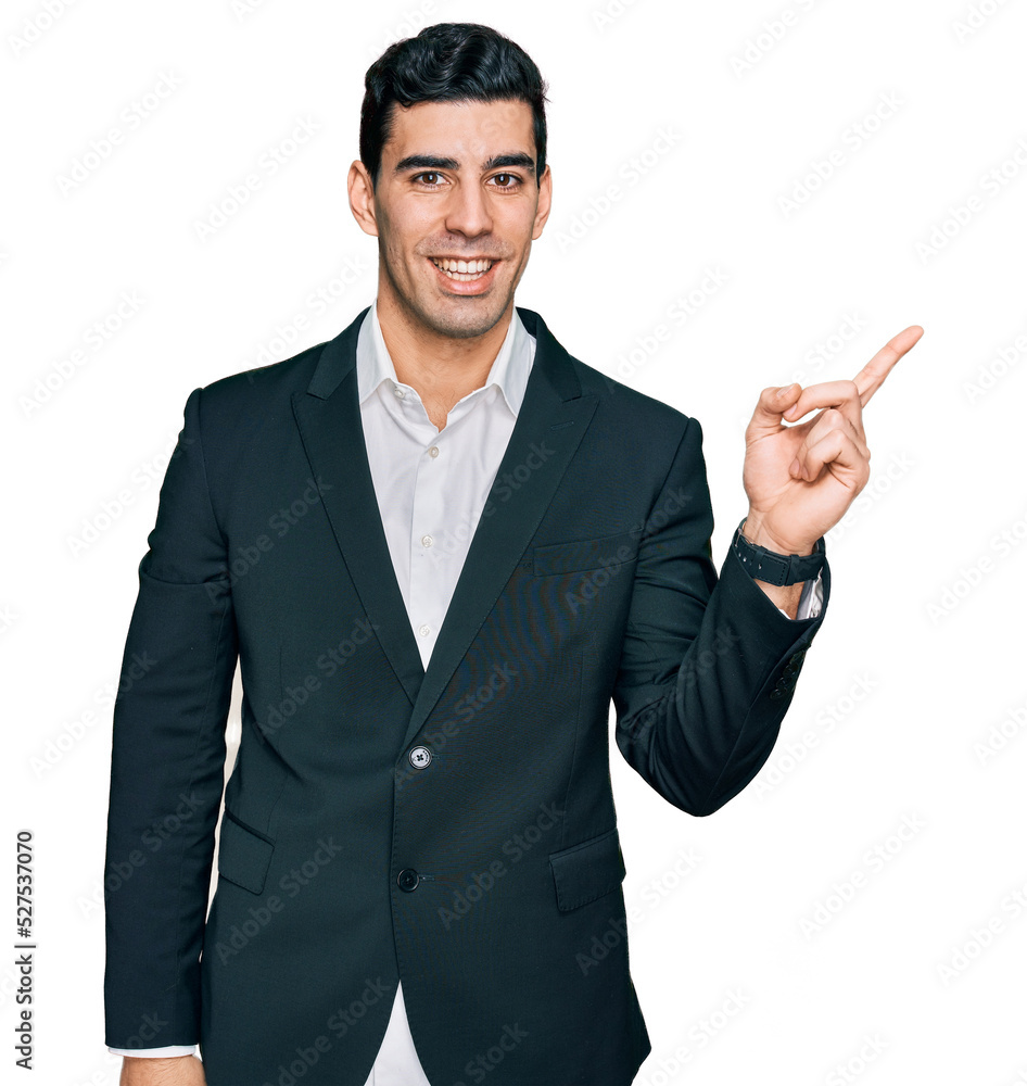 Handsome hispanic man wearing business clothes with a big smile on face, pointing with hand finger to the side looking at the camera. Handsome hispanic man wearing business clothes with a big smile on face, pointing with hand finger to the side looking at the camera.
