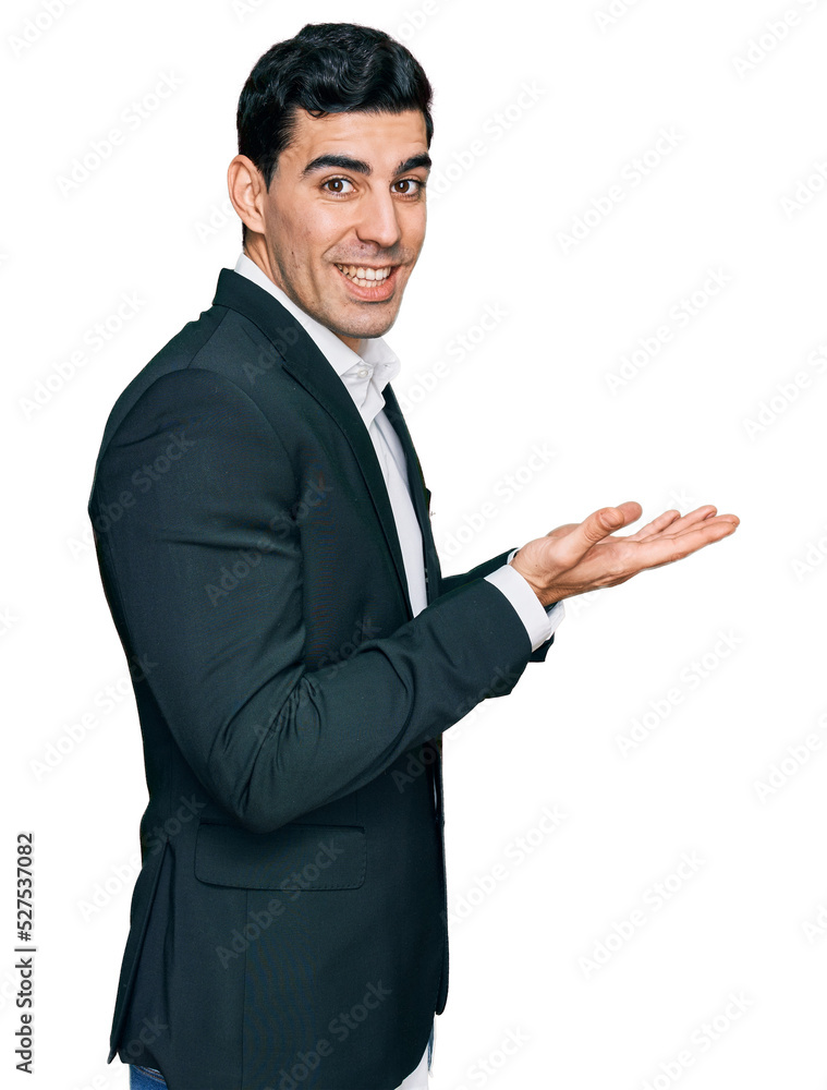 Handsome hispanic man wearing business clothes pointing aside with hands open palms showing copy space, presenting advertisement smiling excited happy Handsome hispanic man wearing business clothes pointing aside with hands open palms showing copy space, presenting advertisement smiling excited happy