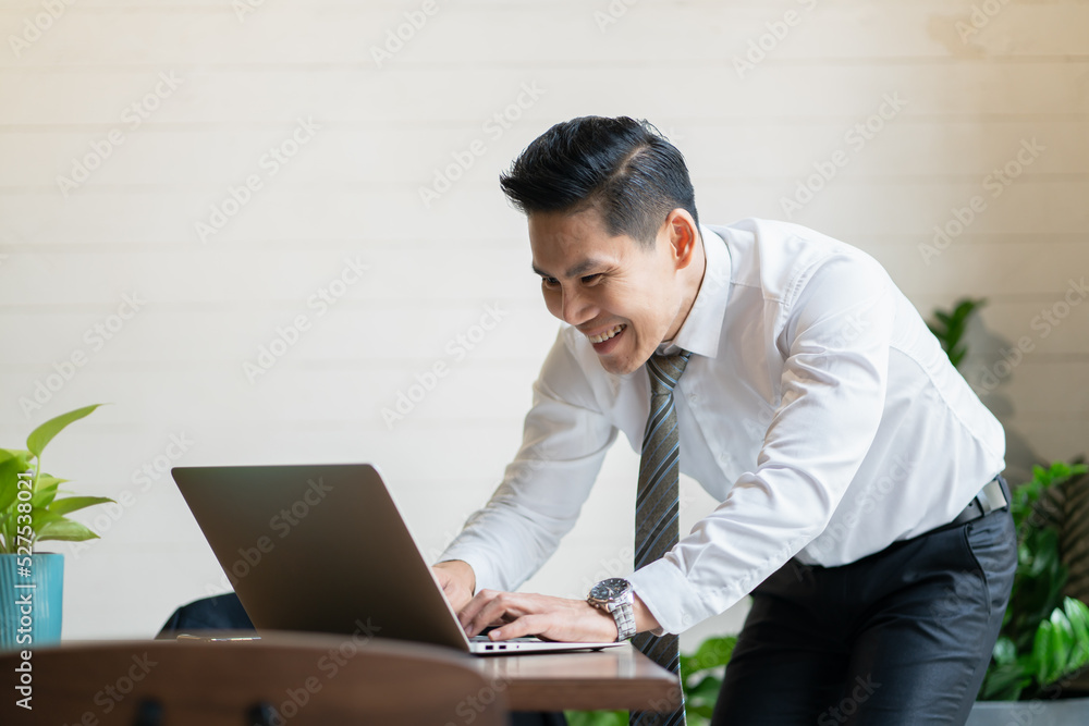 The workplace looks modern with internet work desks.Business Computer Technology Asian Men Businessman Happy Young Adult Online Office The workplace looks modern with internet work desks.Business Computer Technology Asian Men Businessman Happy Young Adult Online Office