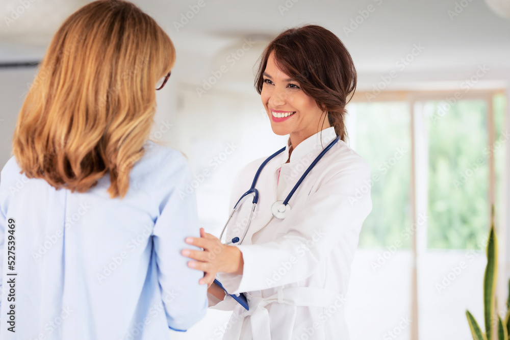 Female doctor consulting with her patient at doctor's office Female doctor consulting with her patient at doctor's office