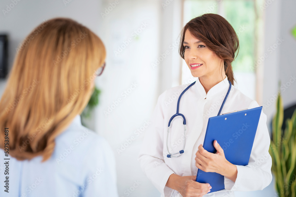 Female doctor consulting with her patient at doctor's office Female doctor consulting with her patient at doctor's office