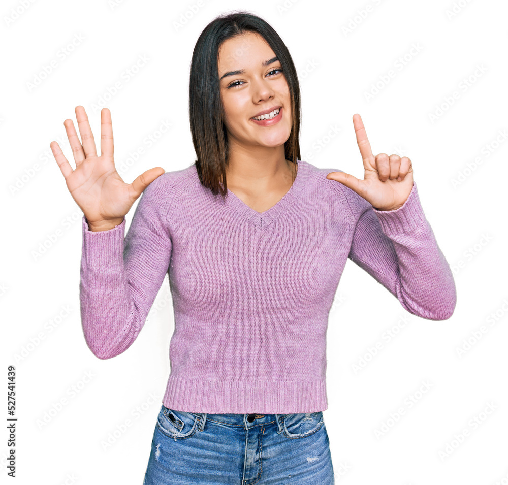 Young hispanic girl wearing casual clothes showing and pointing up with fingers number seven while smiling confident and happy. Young hispanic girl wearing casual clothes showing and pointing up with fingers number seven while smiling confident and happy.