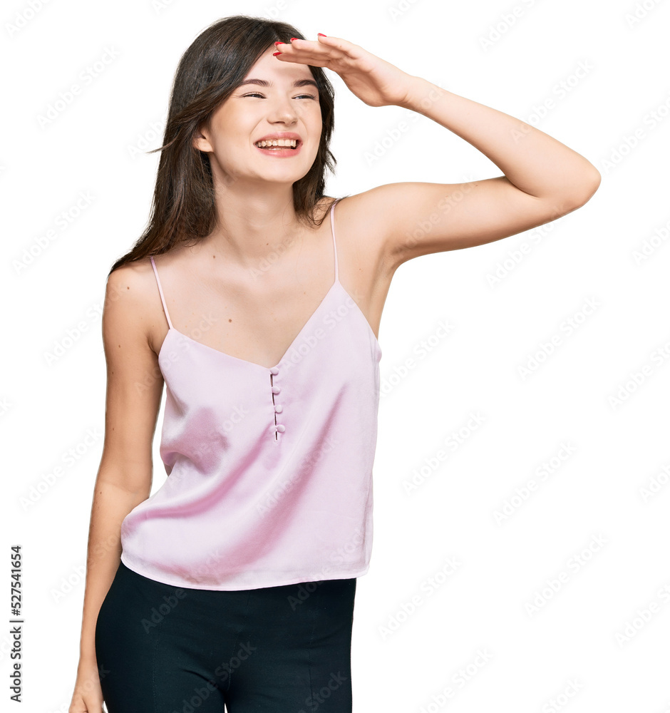 Young beautiful caucasian girl wearing casual clothes very happy and smiling looking far away with hand over head. searching concept. Young beautiful caucasian girl wearing casual clothes very happy and smiling looking far away with hand over head. searching concept.