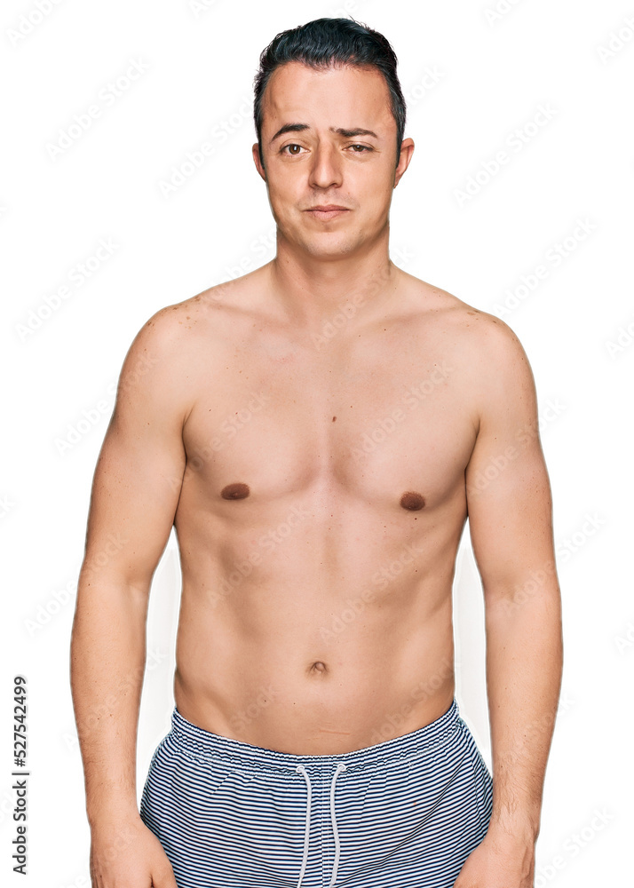 Handsome young man wearing swimwear shirtless skeptic and nervous, frowning upset because of problem. negative person. Handsome young man wearing swimwear shirtless skeptic and nervous, frowning upset because of problem. negative person.