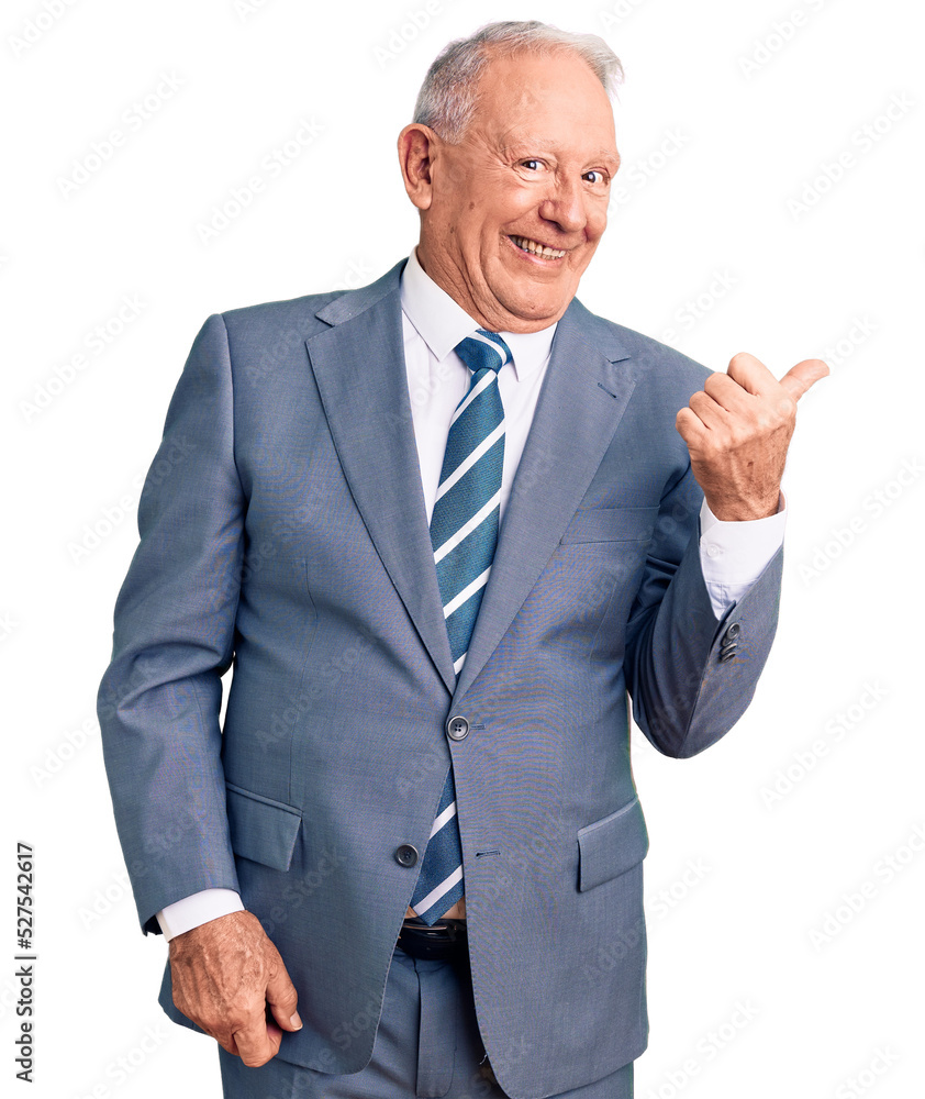 Senior handsome grey-haired man wearing elegant suit smiling with happy face looking and pointing to the side with thumb up. Senior handsome grey-haired man wearing elegant suit smiling with happy face looking and pointing to the side with thumb up.