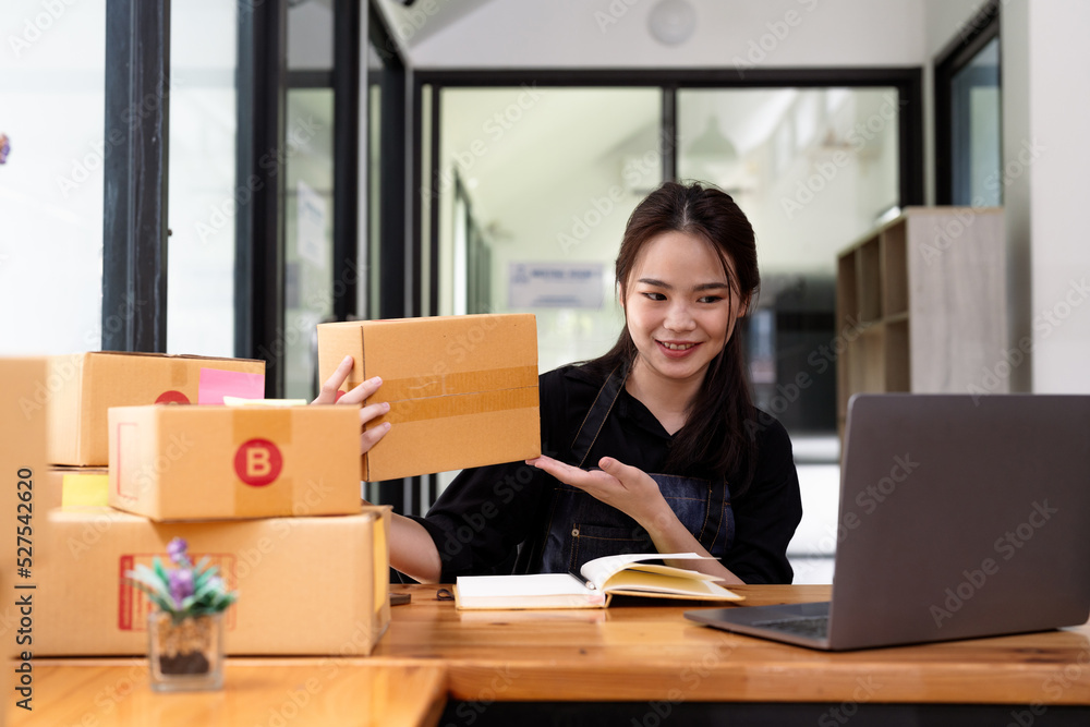 Young start up business woman asian working as SME entrepreneur new business with packaging box, preparing for send to client. Young start up business woman asian working as SME entrepreneur new business with packaging box, preparing for send to client.
