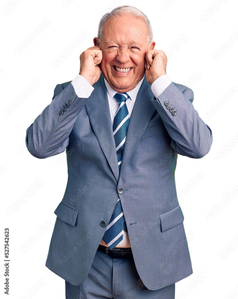 Senior handsome grey-haired man wearing elegant suit covering ears with fingers with annoyed expression for the noise of loud music. deaf concept.