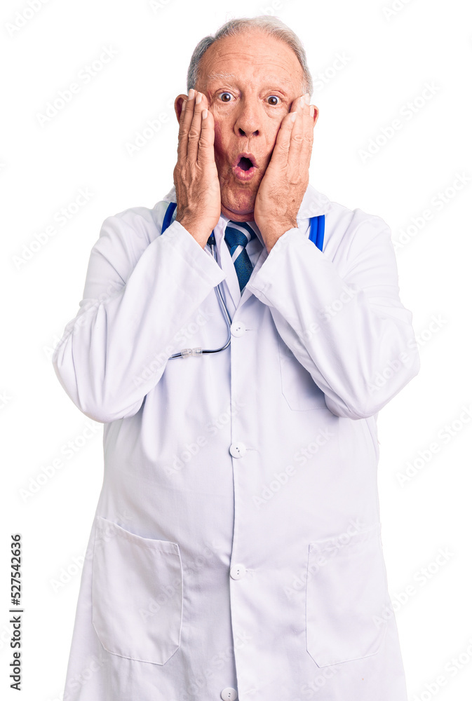 Senior handsome grey-haired man wearing doctor coat and stethoscope afraid and shocked, surprise and amazed expression with hands on face Senior handsome grey-haired man wearing doctor coat and stethoscope afraid and shocked, surprise and amazed expression with hands on face