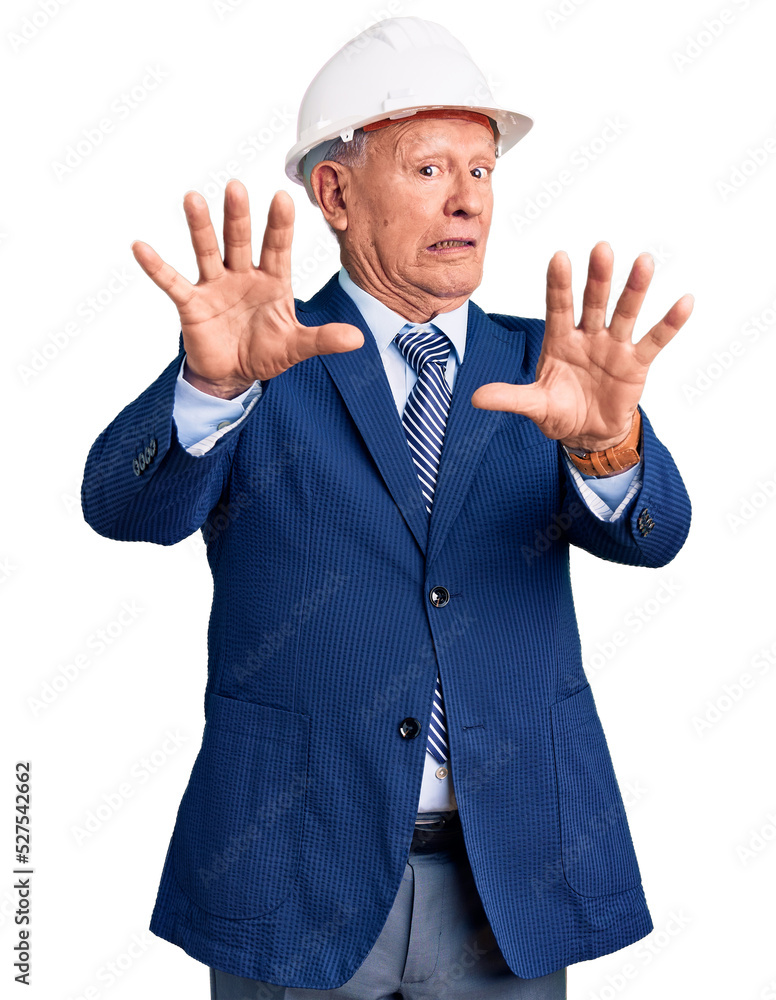 Senior handsome grey-haired man wearing suit and architect hardhat afraid and terrified with fear expression stop gesture with hands, shouting in shock. panic concept. Senior handsome grey-haired man wearing suit and architect hardhat afraid and terrified with fear expression stop gesture with hands, shouting in shock. panic concept.