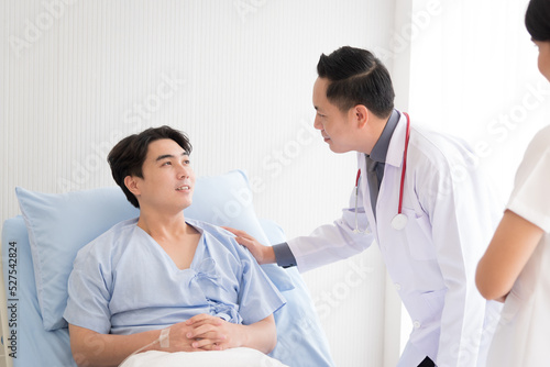 Doctor and nurse in working uniform taking care and diagnosis symptoms on the bed.