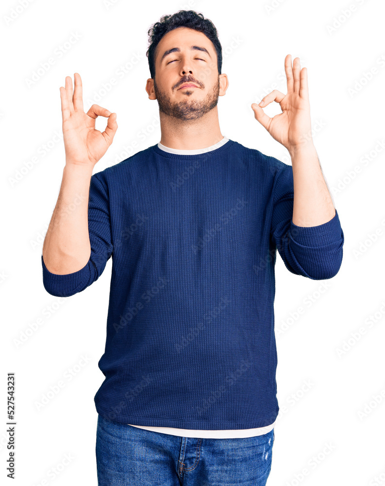 Fototapeta premium Young hispanic man wearing casual clothes relax and smiling with eyes closed doing meditation gesture with fingers. yoga concept.