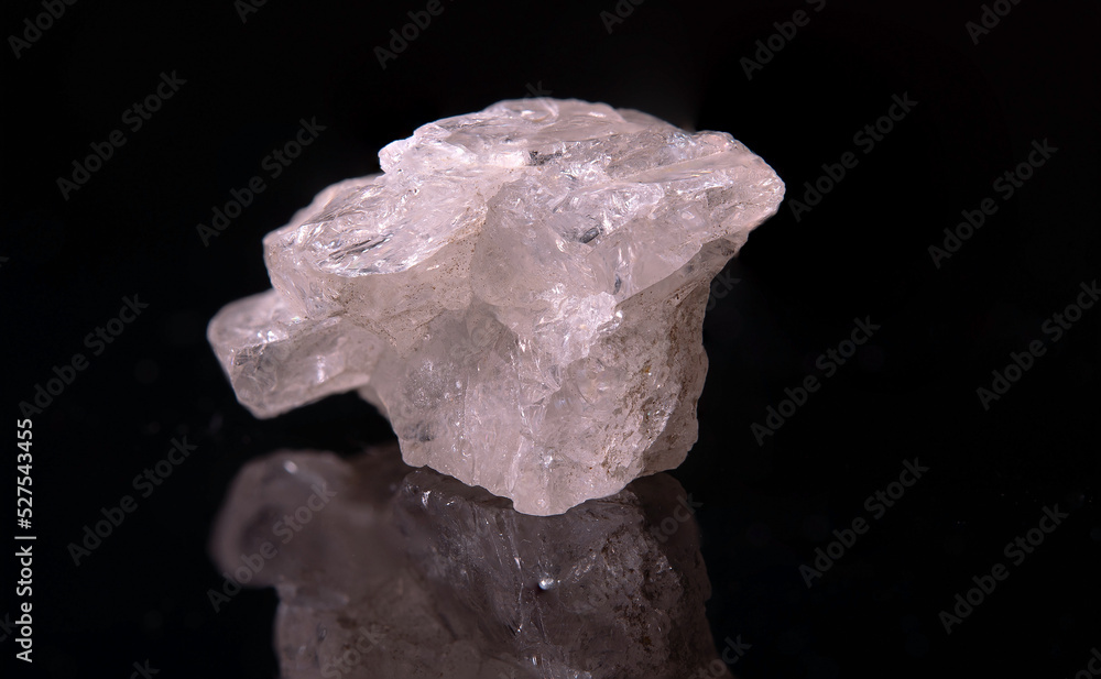 A fragment of a pinkish beryl crystal with small black inclusions