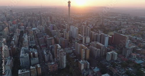 Aerial panning view of the magnificent Johannesburg City Centre at sunset surrounded by smog and pollution. photo