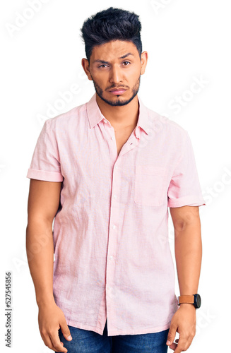 Handsome latin american young man wearing casual summer shirt skeptic and nervous, frowning upset because of problem. negative person.