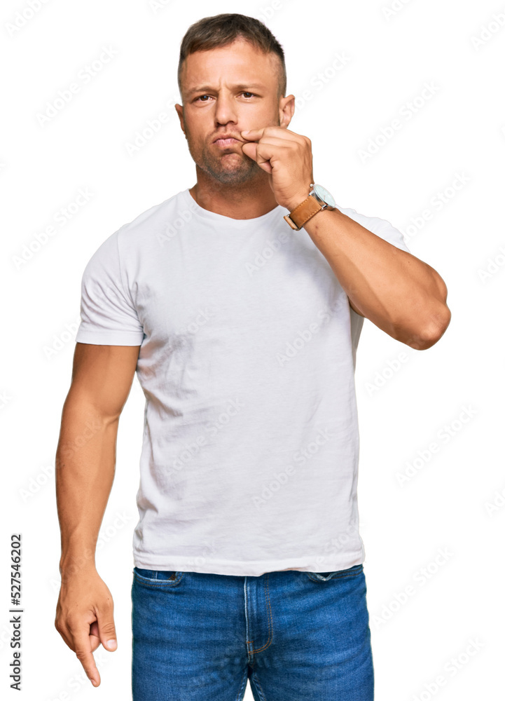 Handsome muscle man wearing casual white tshirt mouth and lips shut as zip with fingers. secret and silent, taboo talking Handsome muscle man wearing casual white tshirt mouth and lips shut as zip with fingers. secret and silent, taboo talking