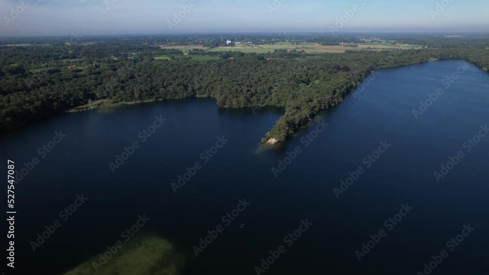 Aerial view of Dutch lake landscape with peninsula on bright early morning with woods in countryside making a picturesque scenery Aerial view of Dutch lake landscape with peninsula on bright early morning with woods in countryside making a picturesque scenery