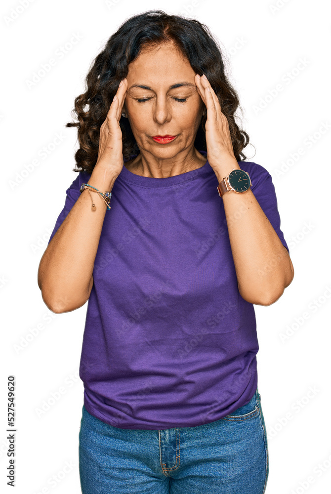 Middle age hispanic woman wearing casual clothes with hand on head for pain in head because stress. suffering migraine. Middle age hispanic woman wearing casual clothes with hand on head for pain in head because stress. suffering migraine.