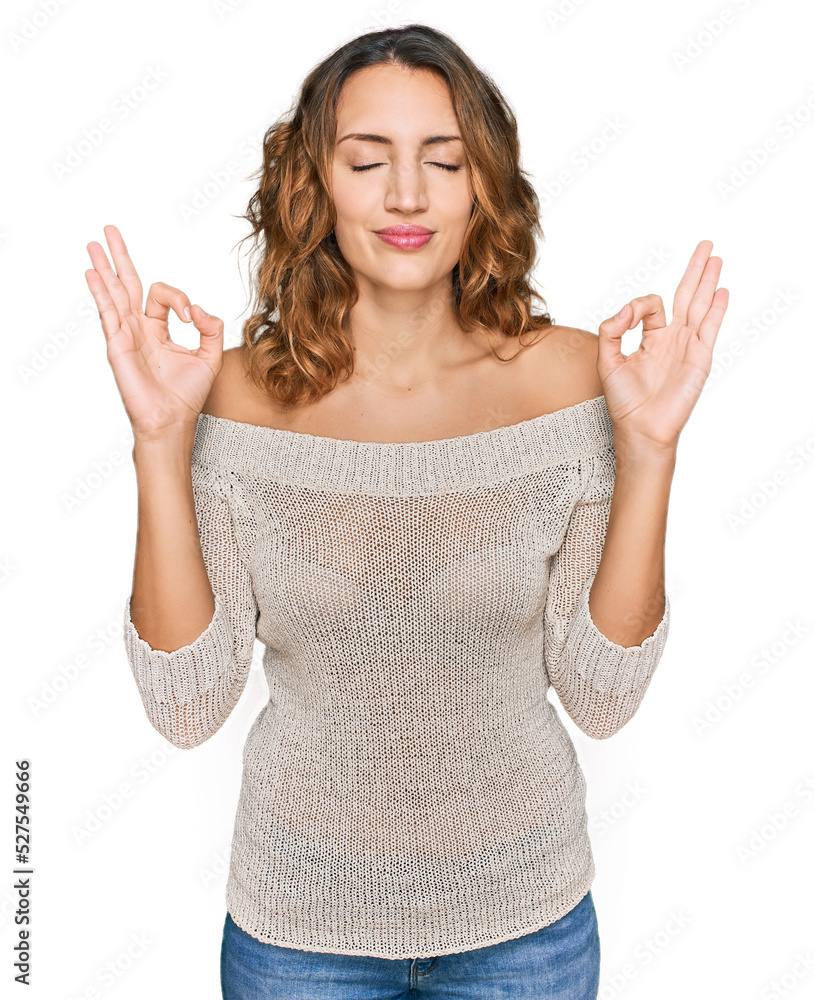 Beautiful young caucasian woman wearing casual clothes relax and smiling with eyes closed doing meditation gesture with fingers. yoga concept. Beautiful young caucasian woman wearing casual clothes relax and smiling with eyes closed doing meditation gesture with fingers. yoga concept.