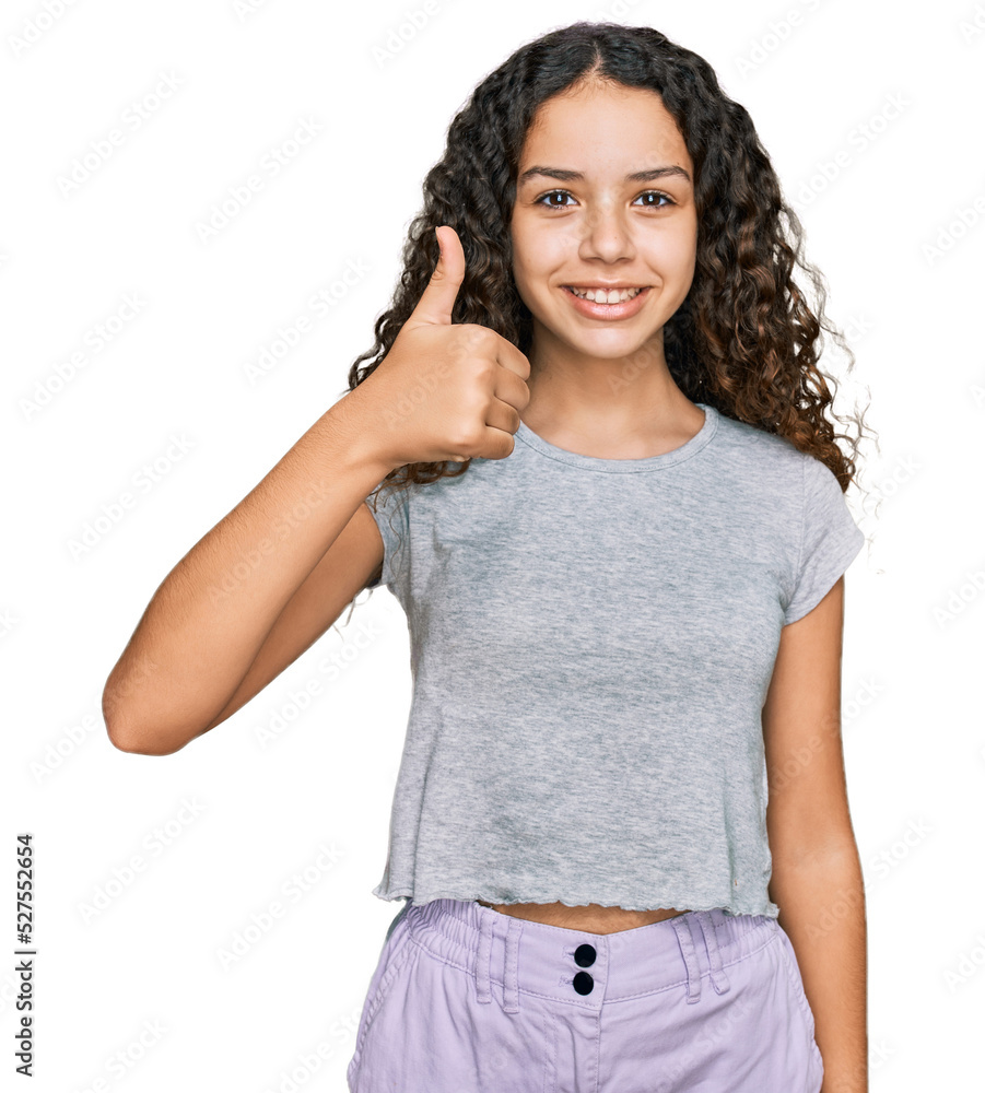 Teenager hispanic girl wearing casual clothes smiling happy and positive, thumb up doing excellent and approval sign Teenager hispanic girl wearing casual clothes smiling happy and positive, thumb up doing excellent and approval sign