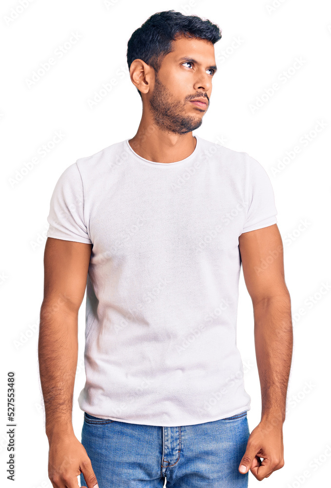 Young latin man wearing casual clothes smiling looking to the side and staring away thinking. Young latin man wearing casual clothes smiling looking to the side and staring away thinking.
