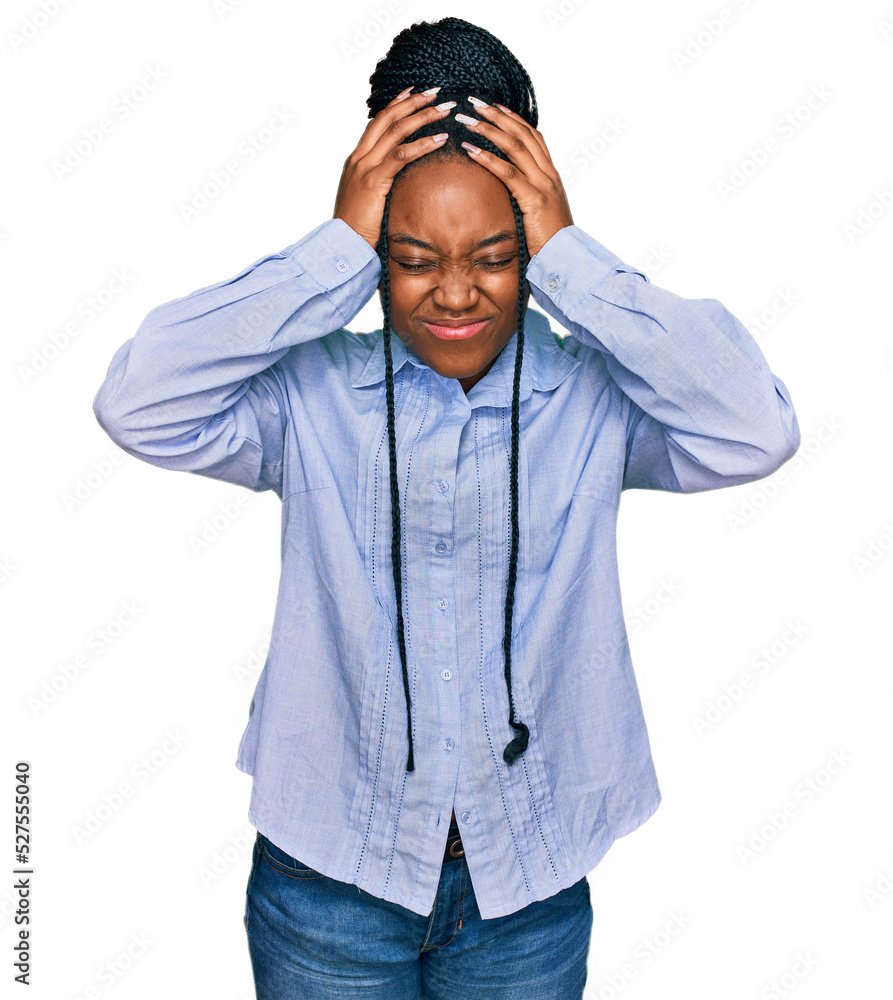 Young african american woman wearing casual clothes suffering from headache desperate and stressed because pain and migraine. hands on head. Young african american woman wearing casual clothes suffering from headache desperate and stressed because pain and migraine. hands on head.