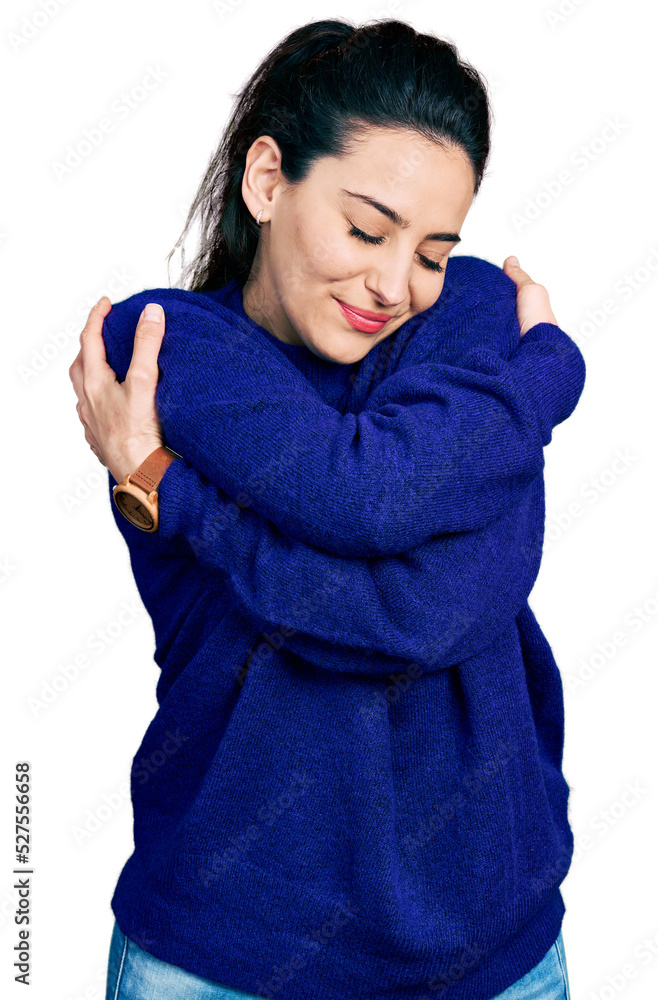 Young hispanic woman wearing casual clothes hugging oneself happy and positive, smiling confident. self love and self care Young hispanic woman wearing casual clothes hugging oneself happy and positive, smiling confident. self love and self care
