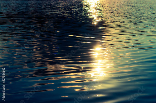 Beautiful sunlight reflection on water surface. Water backgound during sunset.