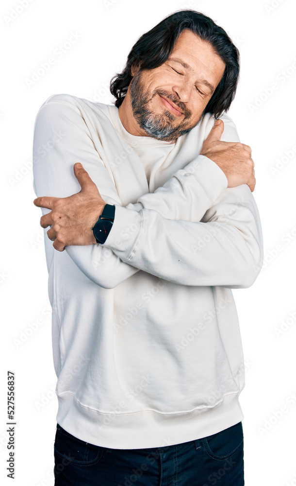 Middle age caucasian man wearing casual clothes hugging oneself happy and positive, smiling confident. self love and self care Middle age caucasian man wearing casual clothes hugging oneself happy and positive, smiling confident. self love and self care