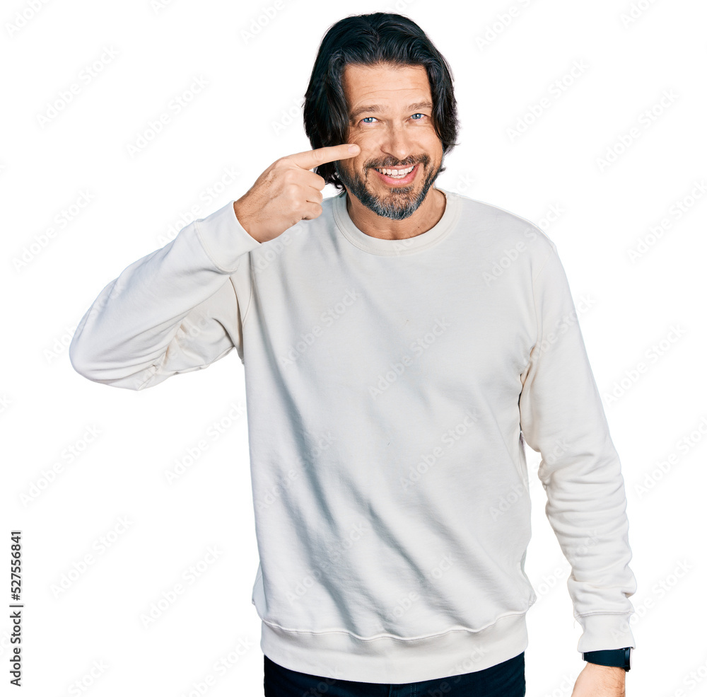 Middle age caucasian man wearing casual clothes pointing with hand finger to face and nose, smiling cheerful. beauty concept Middle age caucasian man wearing casual clothes pointing with hand finger to face and nose, smiling cheerful. beauty concept