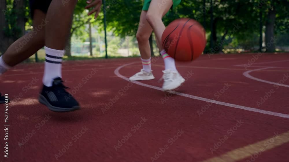 Closeup of man blocking his female training partner in a basketball game, sports Closeup of man blocking his female training partner in a basketball game, sports