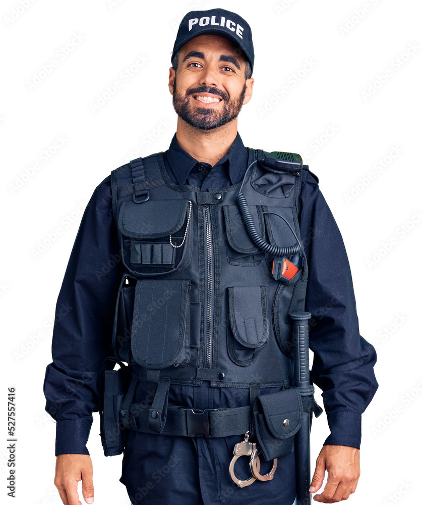 Young hispanic man wearing police uniform with a happy and cool smile on face. lucky person. Young hispanic man wearing police uniform with a happy and cool smile on face. lucky person.