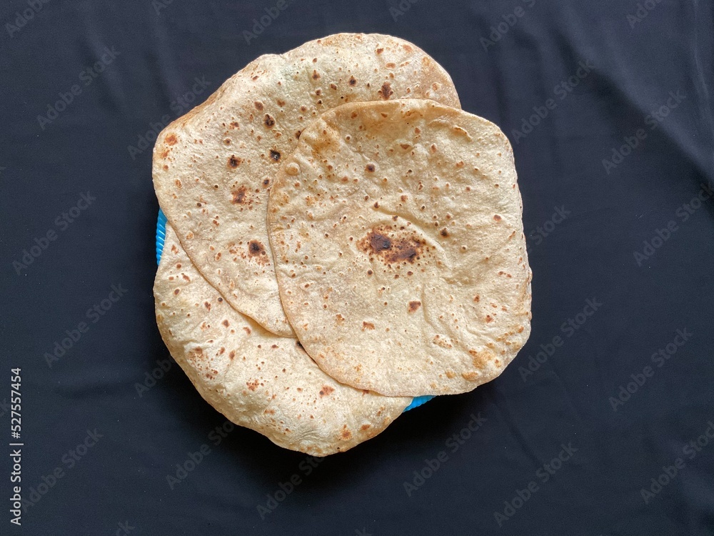 Dasi Roti Desi Roti - Wheat Bread on black background Stock Photo | Adobe Stock