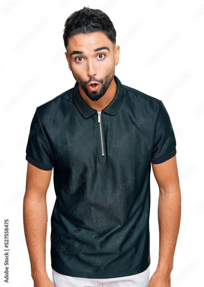 Obraz premium Young man with beard wearing sportswear afraid and shocked with surprise expression, fear and excited face.