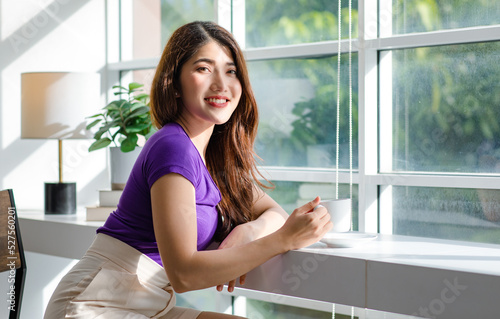 Asian millennial young beautiful female housewife taking break resting relaxing sitting on chair near glass windows smelling drinking hot coffee on table counter bar in living room at home on weekend Free Download Asian millennial young beautiful female housewife taking break resting relaxing sitting on chair near glass windows smelling drinking hot coffee on table counter bar in living room at home on weekend - GFXLoad