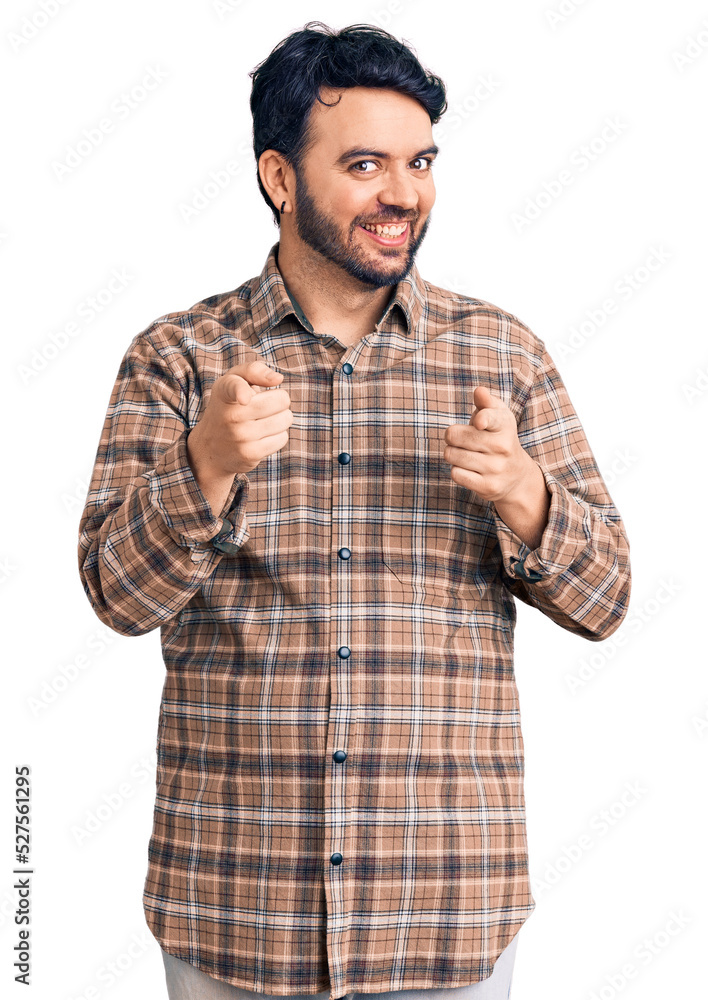 Young hispanic man wearing casual clothes pointing fingers to camera with happy and funny face. good energy and vibes. Young hispanic man wearing casual clothes pointing fingers to camera with happy and funny face. good energy and vibes.