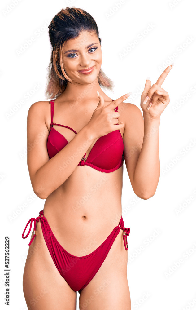 Young beautiful woman wearing bikini pointing aside worried and nervous with both hands, concerned and surprised expression Young beautiful woman wearing bikini pointing aside worried and nervous with both hands, concerned and surprised expression
