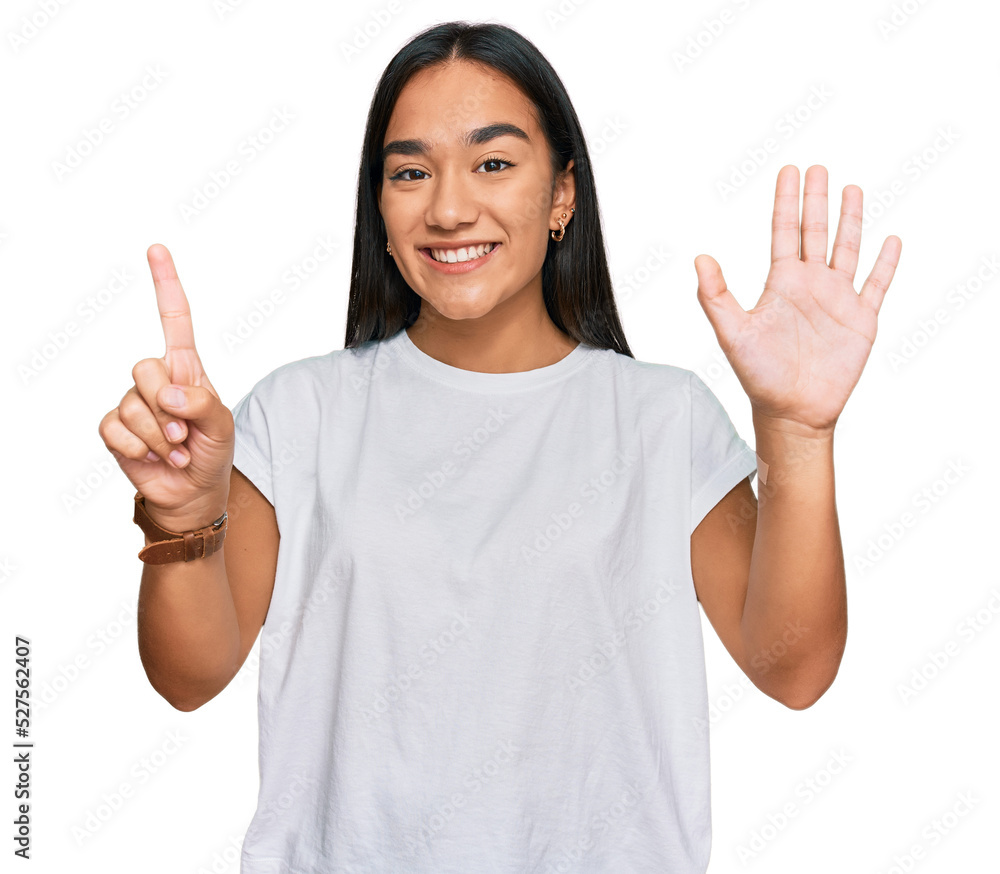 Young asian woman wearing casual white t shirt showing and pointing up with fingers number six while smiling confident and happy. Young asian woman wearing casual white t shirt showing and pointing up with fingers number six while smiling confident and happy.