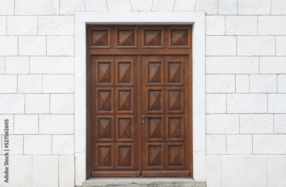 Brown door on white building. External detail of architecture concept Brown door on white building. External detail of architecture concept