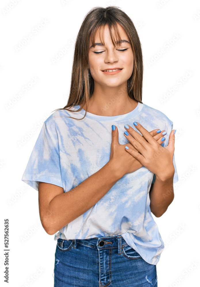 Teenager caucasian girl wearing casual clothes smiling with hands on chest with closed eyes and grateful gesture on face. health concept. Teenager caucasian girl wearing casual clothes smiling with hands on chest with closed eyes and grateful gesture on face. health concept.